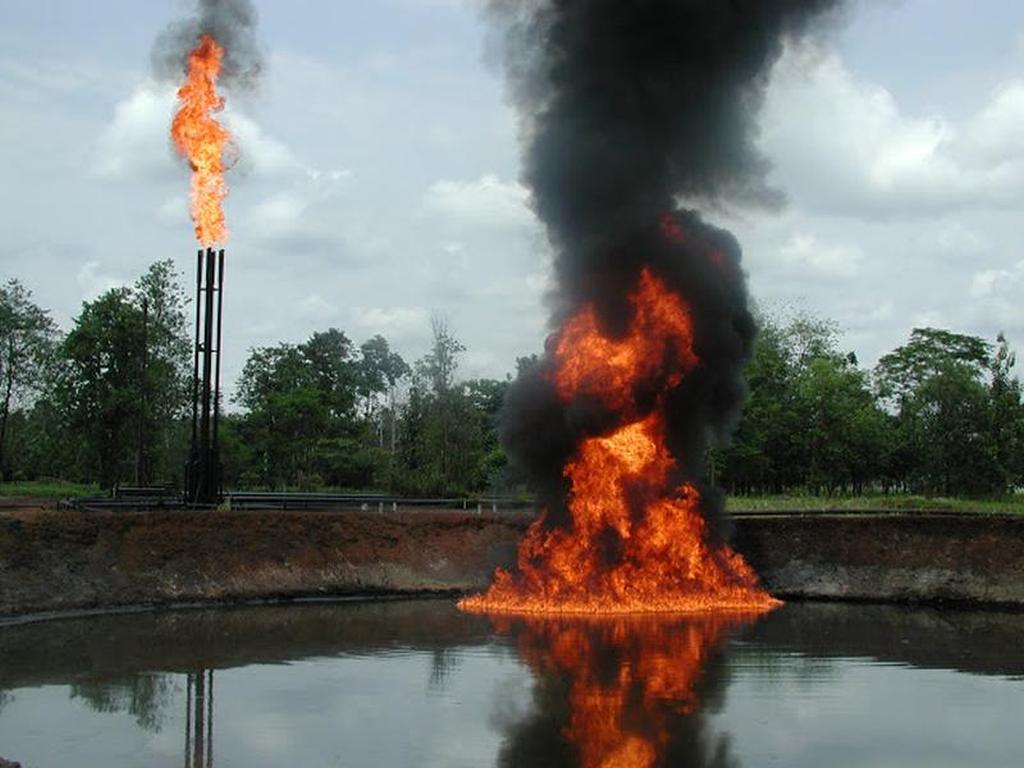 A pool of crude oil and toxic drilling waste burns